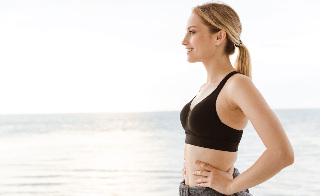 Picture of model on beach in exercise clothes