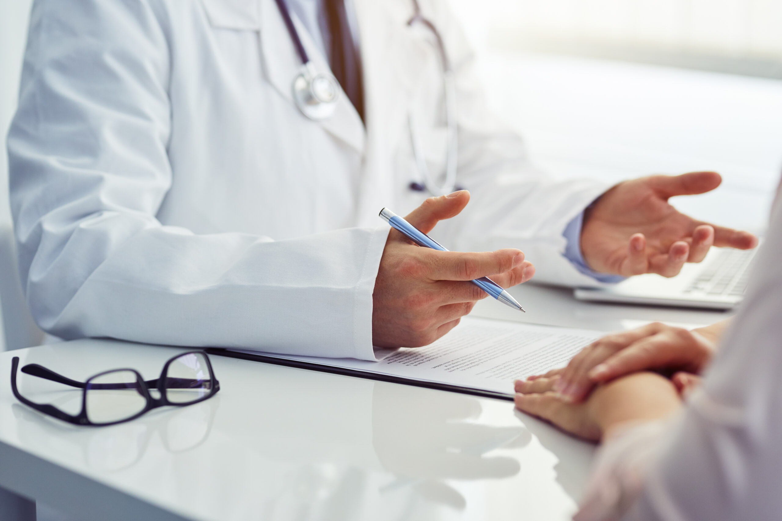 doctor sitting at a table and consulting with patient
