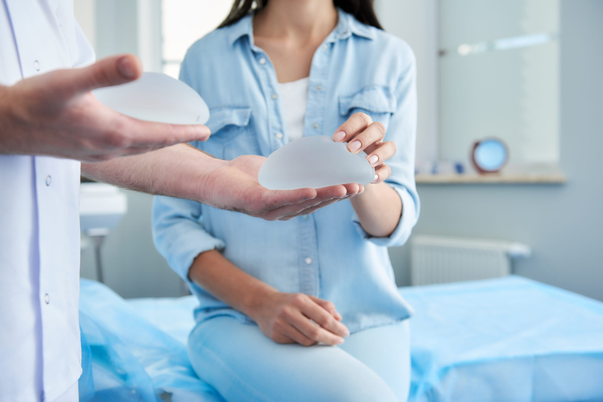 Woman receiving consultation of plastic surgeon