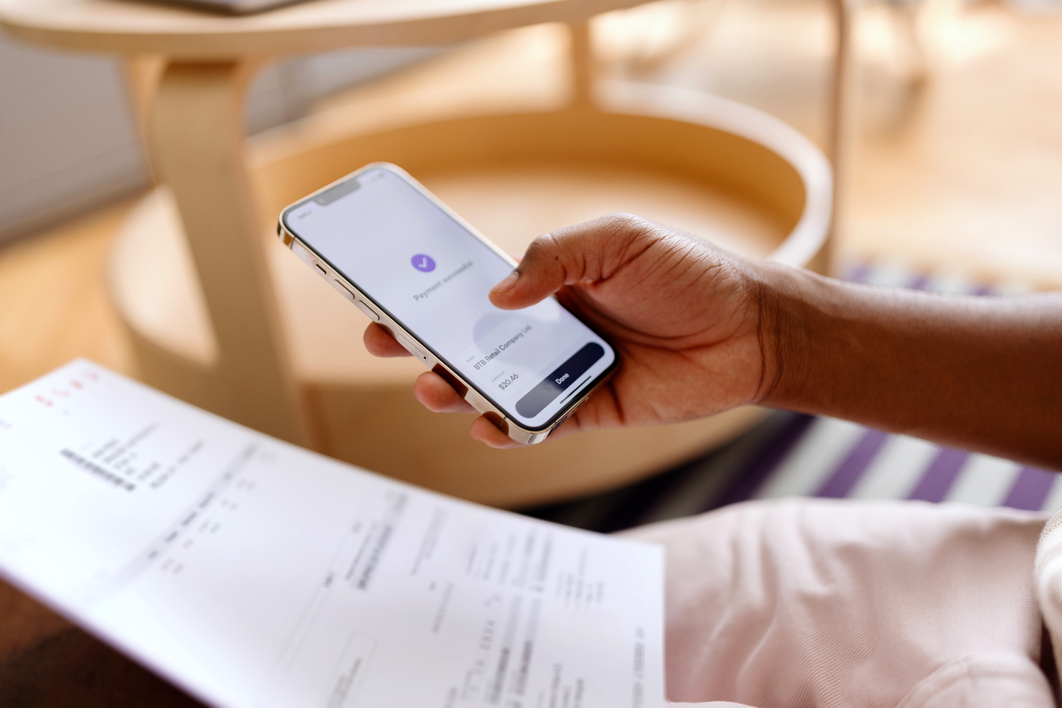 Close-up of an unrecognizable man using online banking on his smartphone