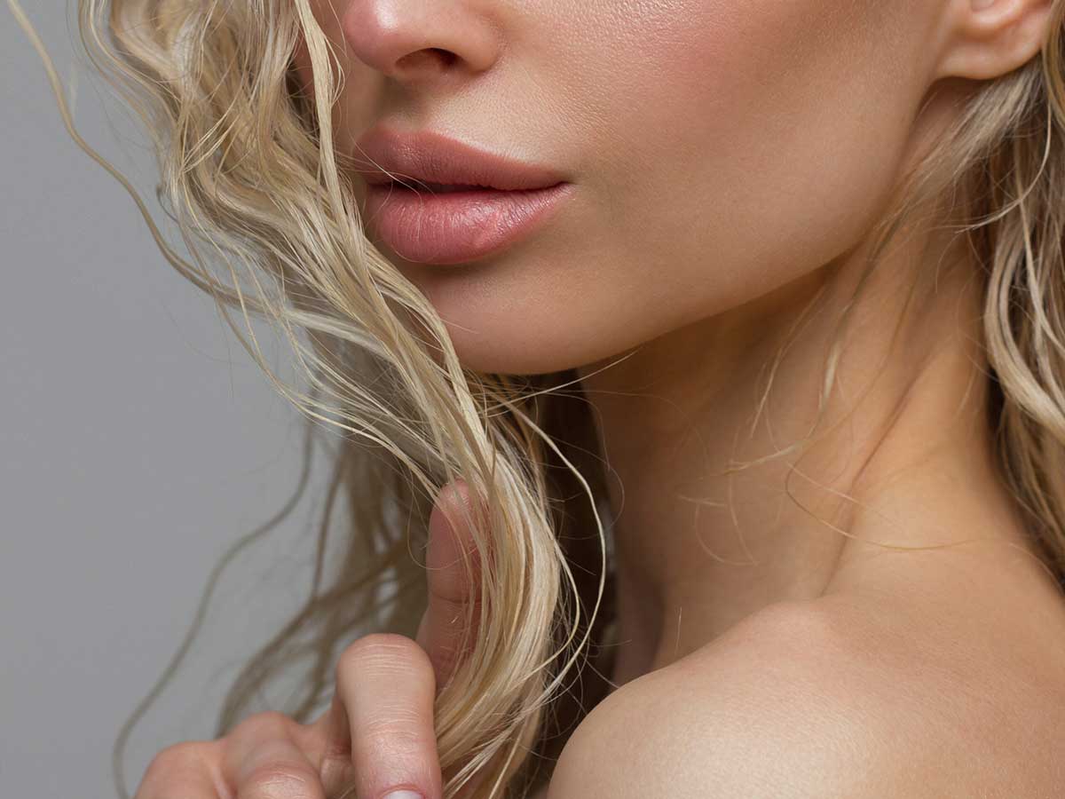 Close up of woman with plump lips after injectables at Forsyth Plastic Surgery