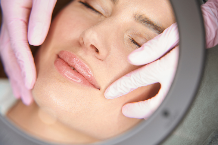Beautician Examines The Nasolabial Folds Of Patient After Beauty Injections