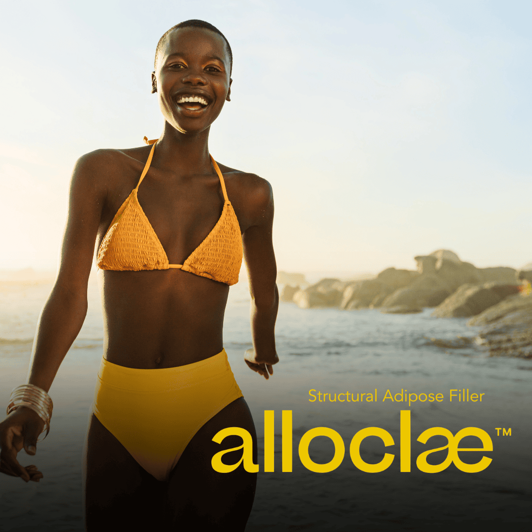 Smiling woman in a yellow bikini on the beach with the alloClae Structural Adipose Filler logo, offered in Winston-Salem, NC